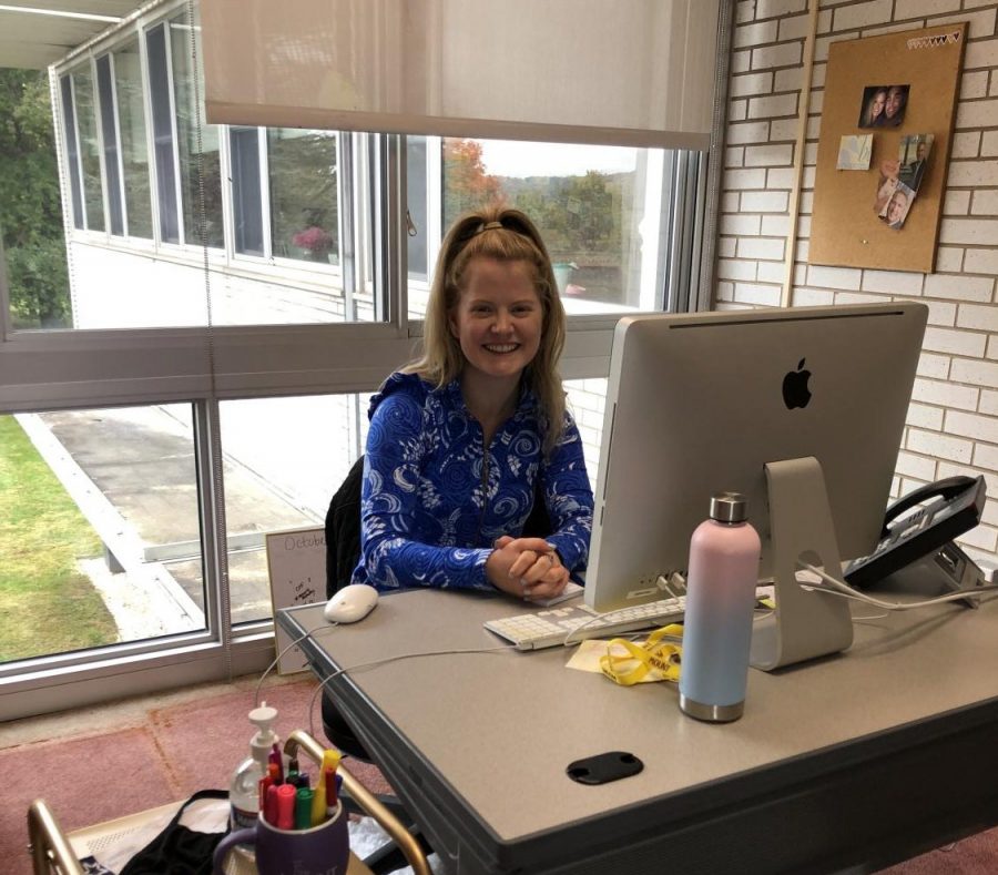 Ms. McGee sitting in her new office by the Alumnae Room