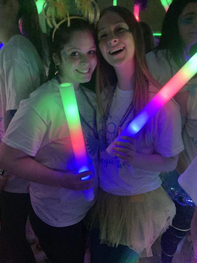 Arianna Corapi 23 and Pauline Rawson 24 pause for a quick during rave hour. CHOP provides Mount with fun light sticks to complement the rave. 