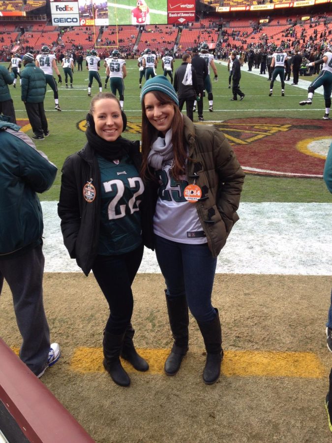 Bridget and her college best friend on field with the Eagles at FedEx Field