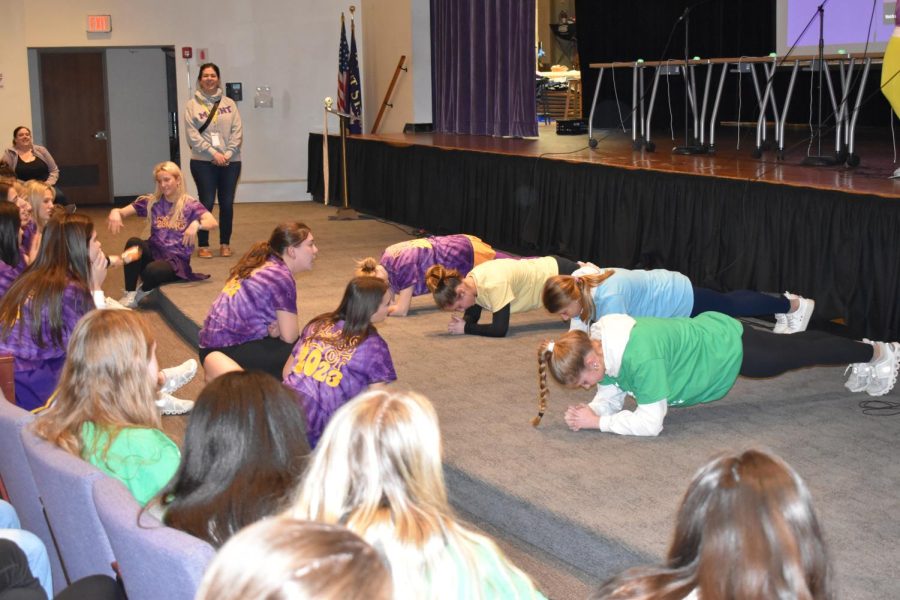 Faith Decarlo '23, Anna McBride '24, Sophia Stromberg '25 and Alexa Buist '26 compete in the Charity Day 2023 planking competition, breaking the 2022 record of the 8 minute plank.