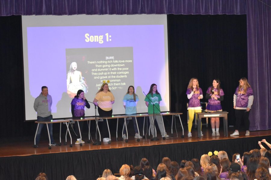 Mr. Holdren, Maddi Allen '23, Kate Tannenbaum '24, Jill Marcolina '25 and Layla Seward '26 listen closely to Hamilton's "The Schuyler Sisters" during an intense musical theater round of Finish the Lyric. 
