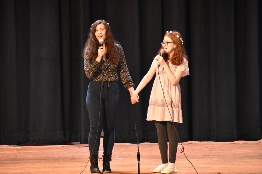 Gianna Aregnano '23 and Sarah Farrell '23 hold hands affectionately during their duet of "Here Comes a Thought" from Cartoon Network's "Steven Universe." 