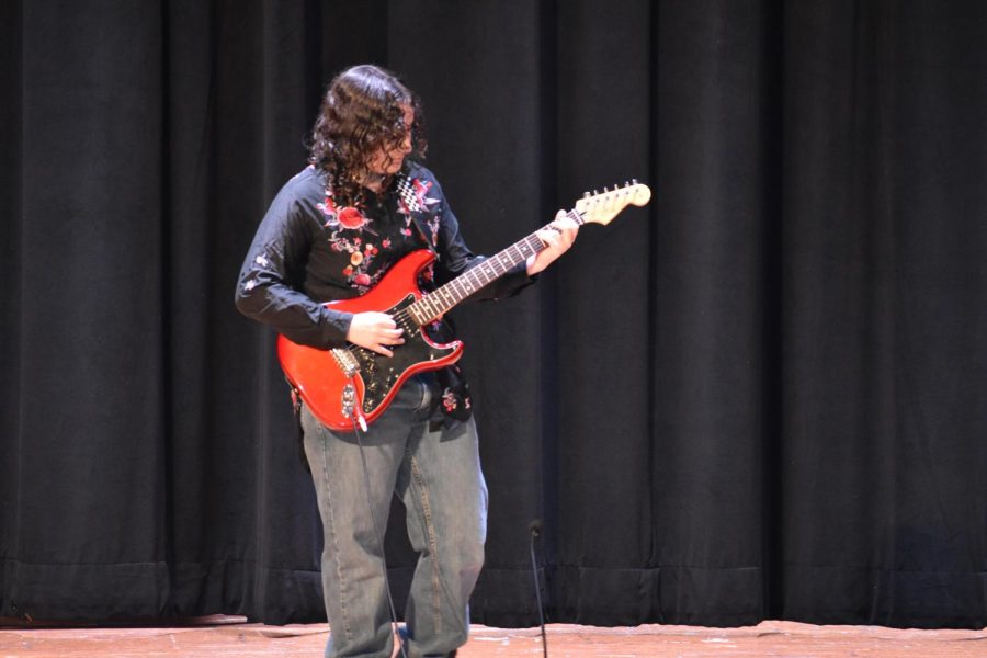 On her electric guitar, Lee Quinn '24 rocks out to "Do I Wanna Know?" by Arctic Monkeys during Charity Day 2023.