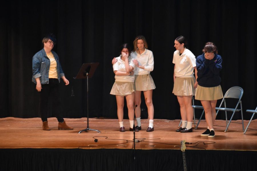During a Charity Day 2023 skit, Devin Loome '23 comforts Maddi Allen '23 after Mrs. Fabrey breaks the news of Queen Elizabeth II's tragic death. 
