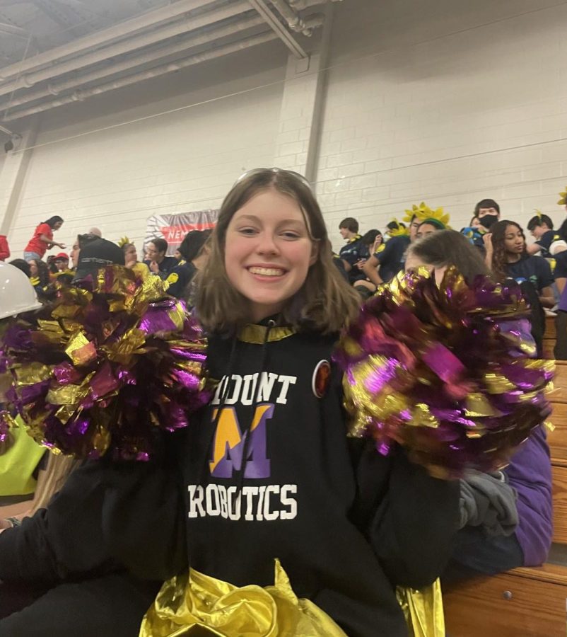 Evelyn ‘Eve’ Prendergast ‘25 waves her pom poms  enthusiastically to cheer on the team after the win. 
