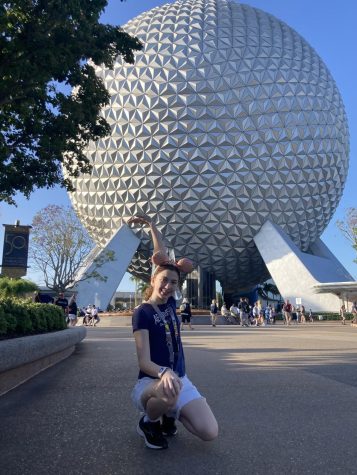 Erin Olympio holds up Epcot with the strength of one hand. 