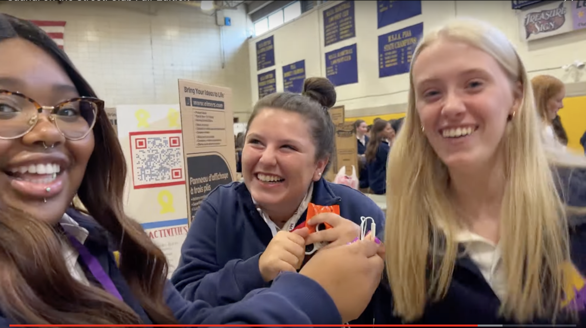 Nora Feliciani and Sarah Klunk laugh with Saanai Jones.