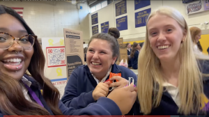 Nora Feliciani and Sarah Klunk laugh with Saanai. 