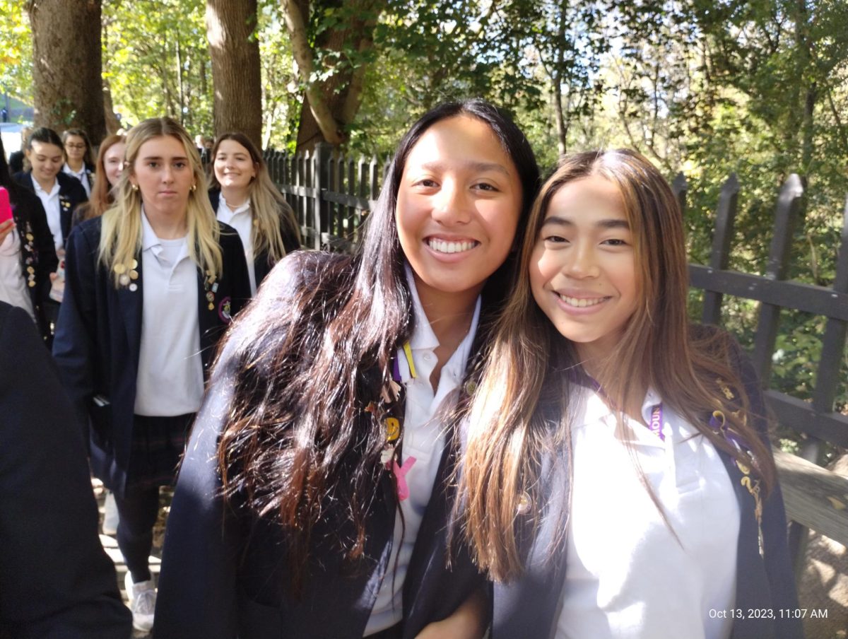 Aubrei Ranile 24 and Caroline Lynch 24 stop to take a lovely picture under the trees as the sun shines through. 