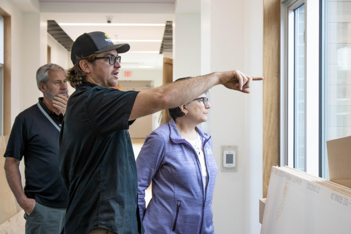 From left to right: Mr. Guy Petrucci, Tristan Fenimore and Sister Charlene looking at new windows in hallway that coincide with all of the large windows throughout Mount. 