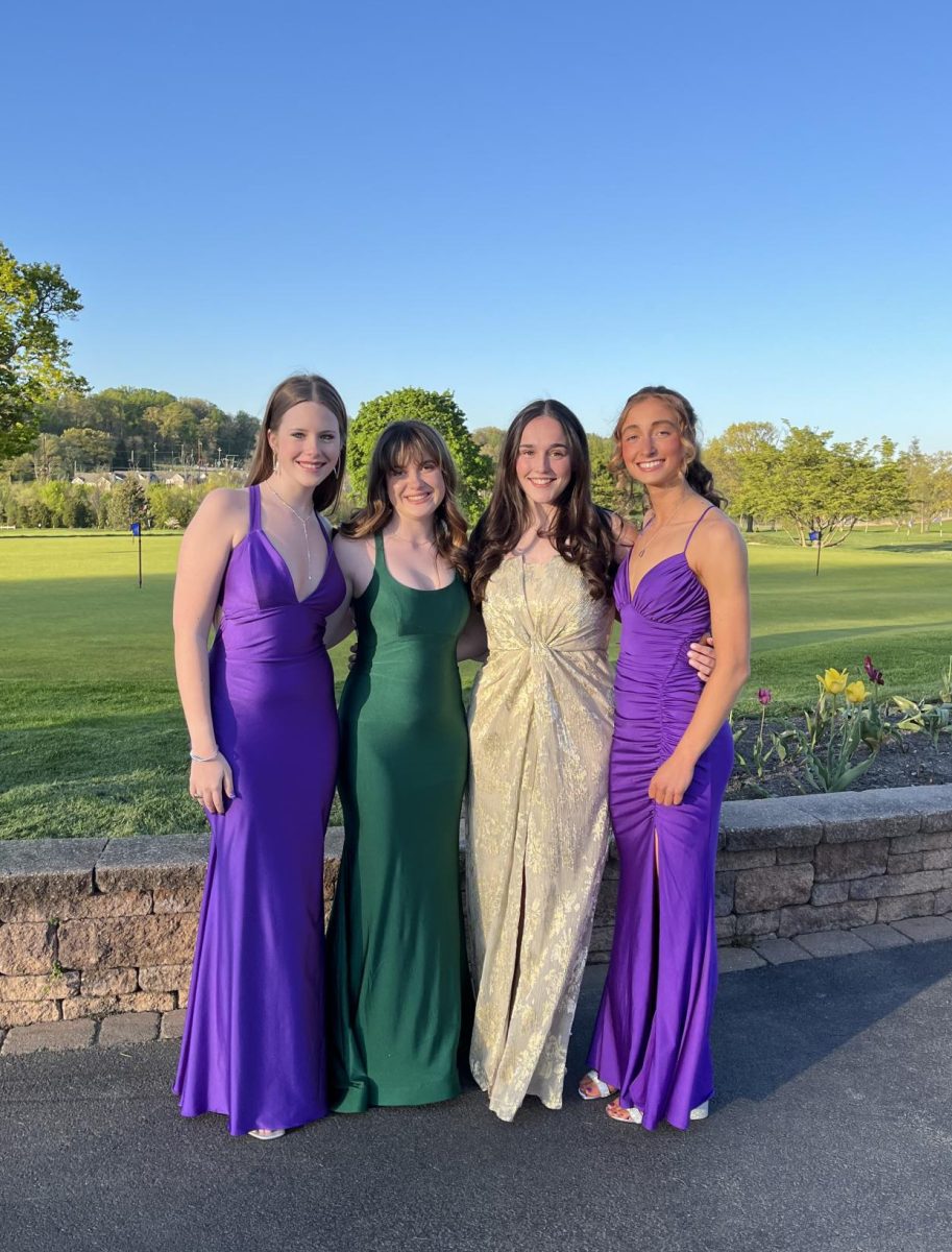 Natalie Burrell ‘24, Lola Figueroa-Clark ‘24, Carly Oniskey ‘24, and Norah McGlynn ‘24 smile for a photo at Sandy Run Country Club.