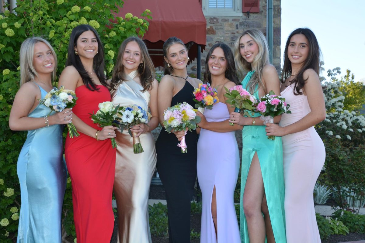 Eva Kelly '24, Maggie Rezza ‘24, Josey Liebsch '24, Vivian Moore '24, Julia Burns '24, Audrey Kukla '24, and Julia Brandon '24 pose at senior prom pre pictures. 