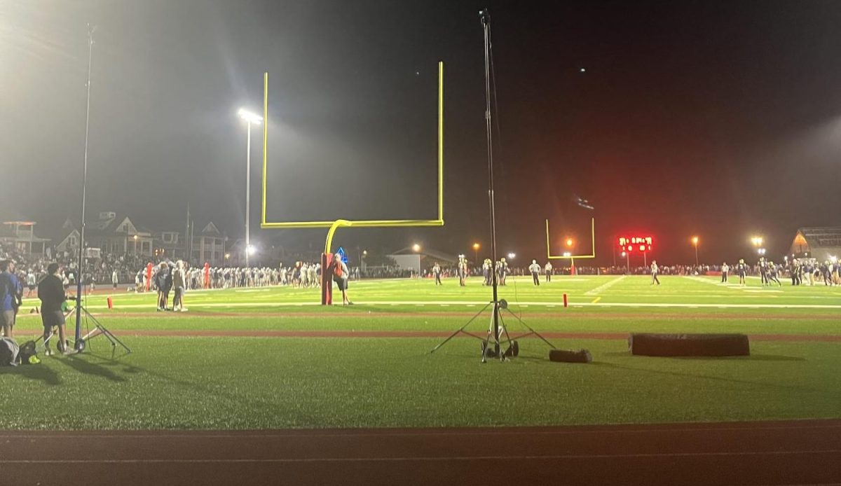 Malvern and La Salle football players prepare for the fourth quarter on the field.