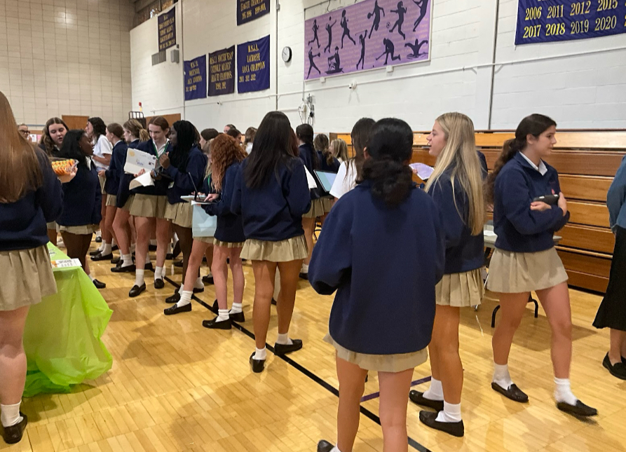 Potential club members swarm the club tables to determine which co-curriculars they want to join. 