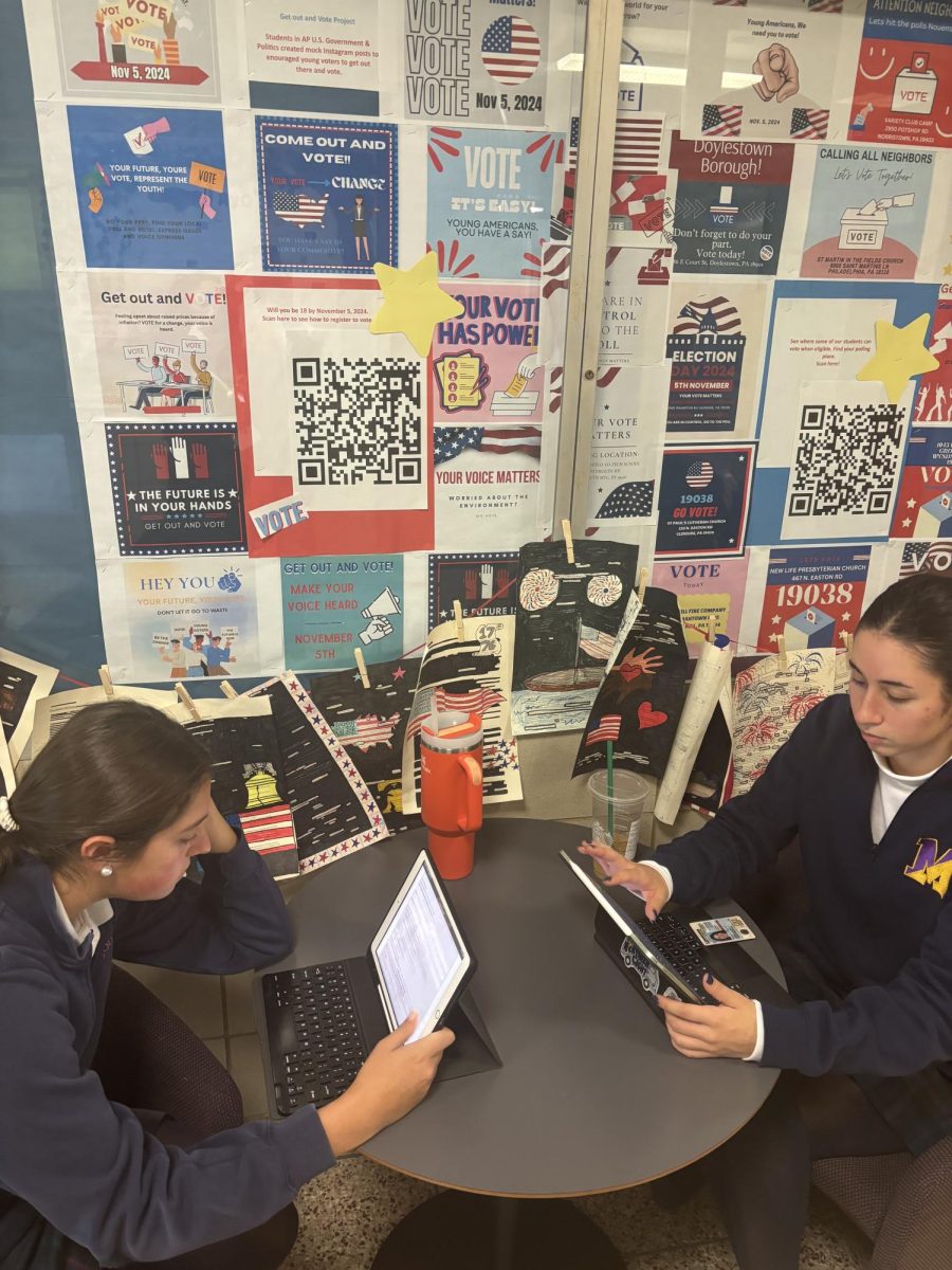 Ava McDonald ‘25 and Veronica Vacca ‘25 register to vote outside of Ms. Schools’ room. 
