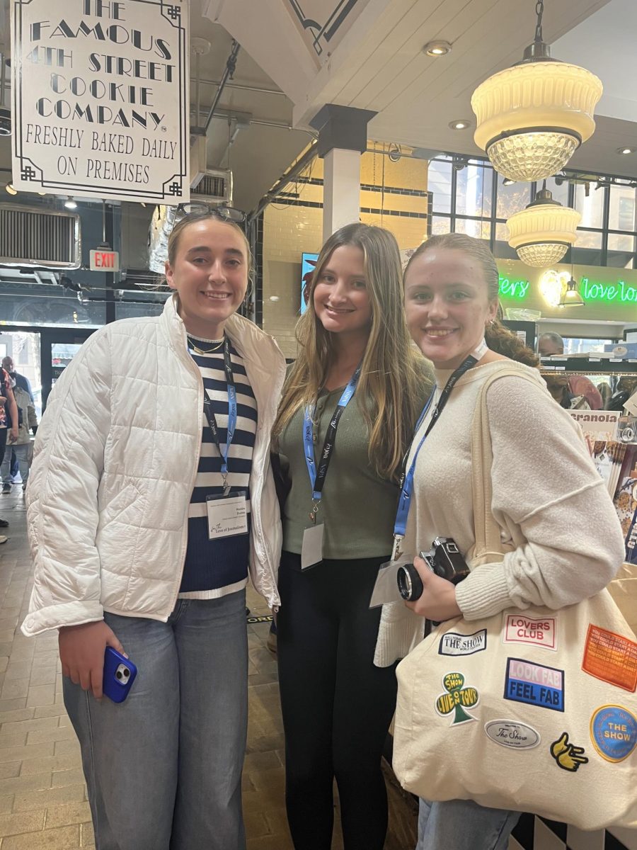 Maddie Dudley, Reegan Clouser, and Maddie Kelly in reading terminal market buying lunch 