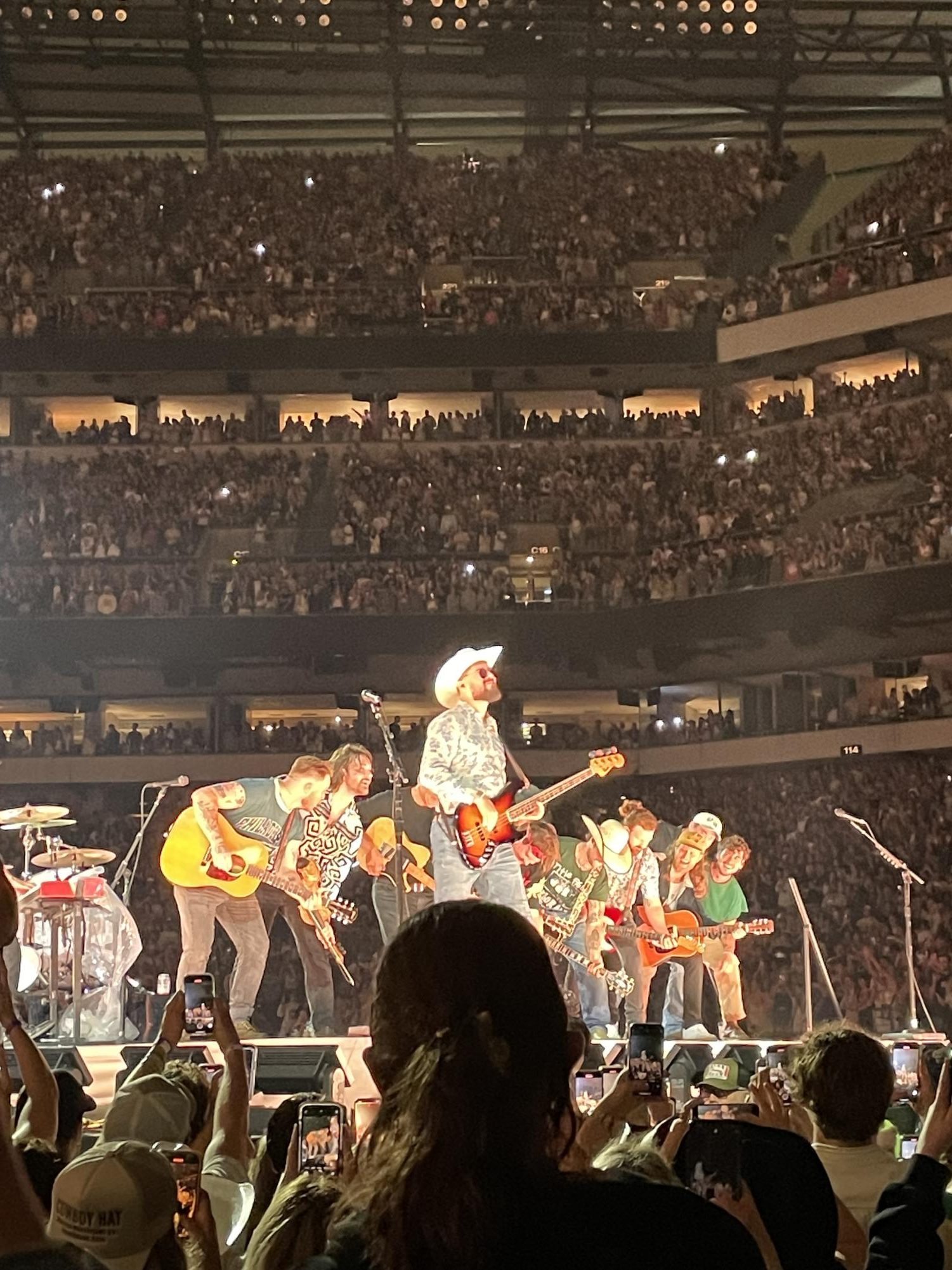 Zach Bryan (far left) jams out during the encore song “Revival” at his 2024 Quittin’ Time tour. 