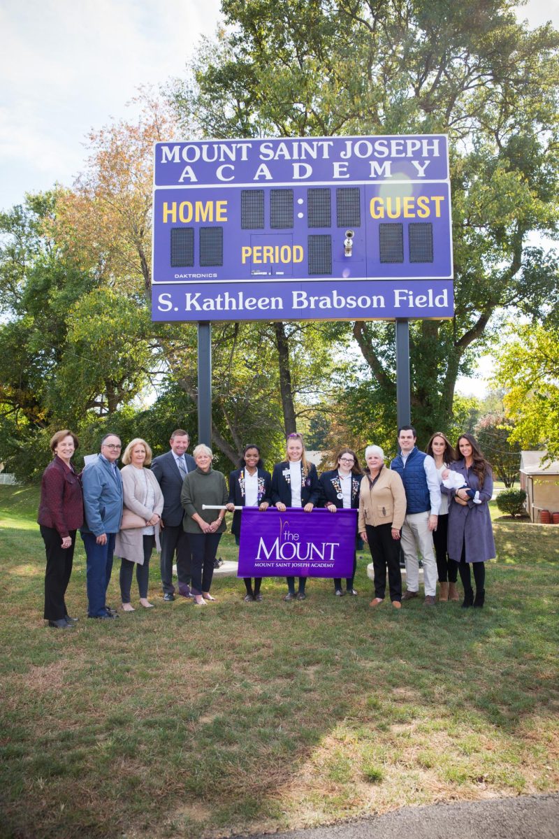 Sister Mary Dacey with the Brabson family at the turf field dedication. 