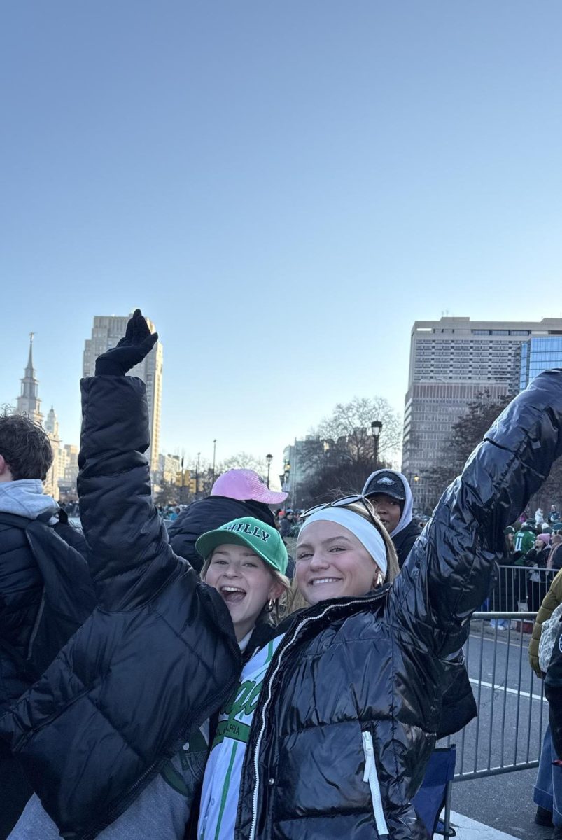 Avery Lasky ‘26 and Allie Seweryn ‘26 raise their hands out of excitement for the Birds! 

After this photo the Eagles float drove by.  