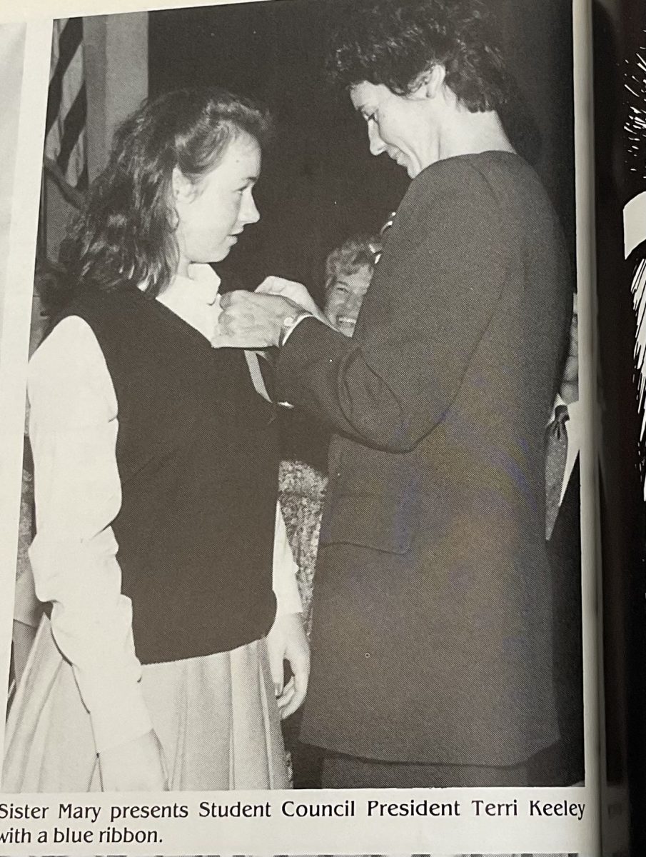 Sister Mary Dacey presenting 1994 student council member, Terri Keeley, with her ribbon.