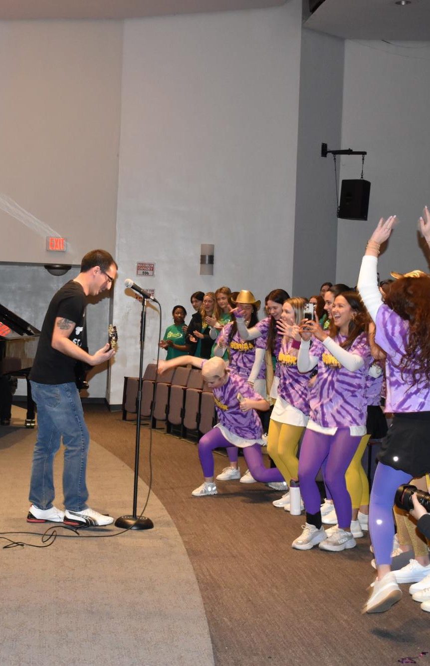 Mounties ecstatically cheer and jump as Guy and the Guys perform for the second time ever in Charity Day history.