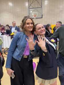 Avery Lasky ‘26 posing with her mom, Daniele Penzarella Lasky ‘94, with their class rings. 
