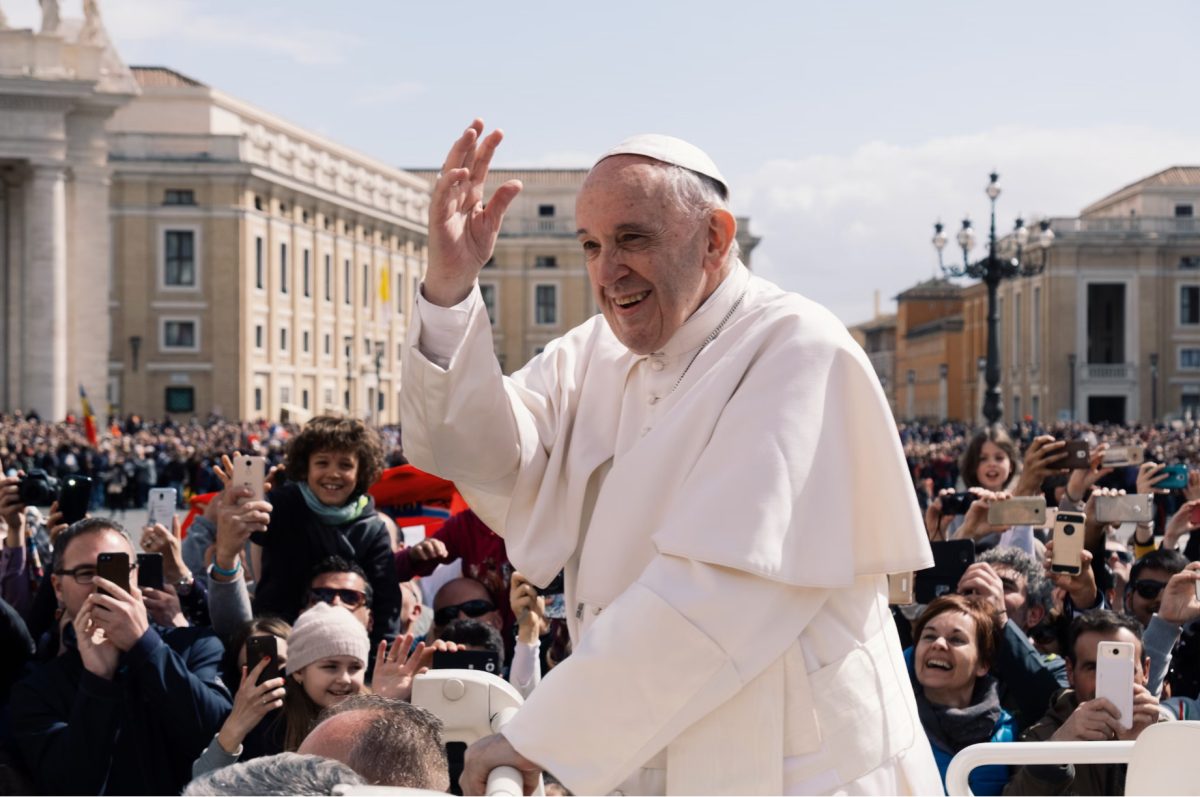 Pope Francis waving out to the public.