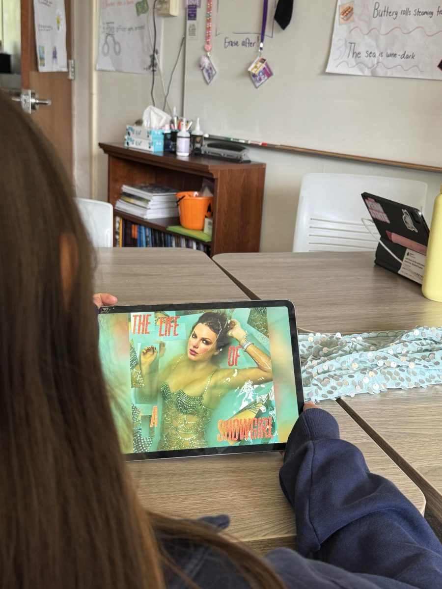 A Mountie looks at the album cover of "Life of a Showgirl."