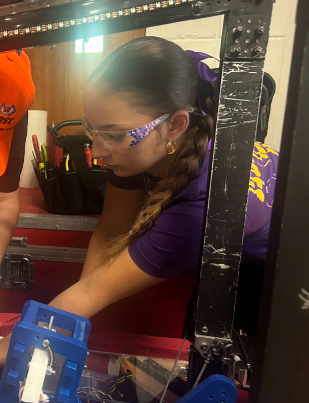 Co president and senior Daria Yohe ‘26 makes adjustments to the Firebirds’ robot for the 2025-2026 season. GirlPOWER, held in the Mount’s gym on September 20th of this year, was an all day event in which multiple schools sent their robotics teams to compete against each other in the ring. 

“By organizing and planning GirlPOWER every year, our team facilitates in the empowerment of Women in STEM, one of the core values of the Firebirds.” Daria Yohe, ‘26 said, “Although it is very difficult to hold this competition in the limited space we have, the excitement surrounding this competition and the memories made every year make it absolutely worth the challenge.”
