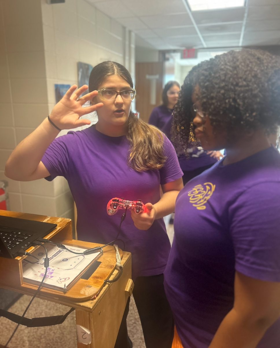Ana Telischak ‘27 and Halo Hall ‘27 go over the plan before sending their robot into the ring. 

Each team has a slot of time before diving in for the competition to tighten any bolts, make a plan, and drive up team morale. 

“I’m the current Vice President of Administrative Affairs, was the driver in competitions last year, and am on the Build subteam.” Ana Telischak, ‘27 said. “A point of pride for me is the fact that our team, the longest running all-girls FRC team in the world, is able to provide a space where girls interested in STEM can pursue new avenues and opportunities”. 

Telischak has participated in Firebirds every year since becoming a Mountie, and she can absolutely see herself continuing her passion and dedication to the team in her Senior year. “GirlPOWER has also brought me closer to my friends and provided me with opportunities to bond with girls I otherwise would never have interacted with.  From bonding while setting up the field to talking with our alliance partners and making friends, I’ve benefited socially and mentally, learning more than I could have ever imagined.”
