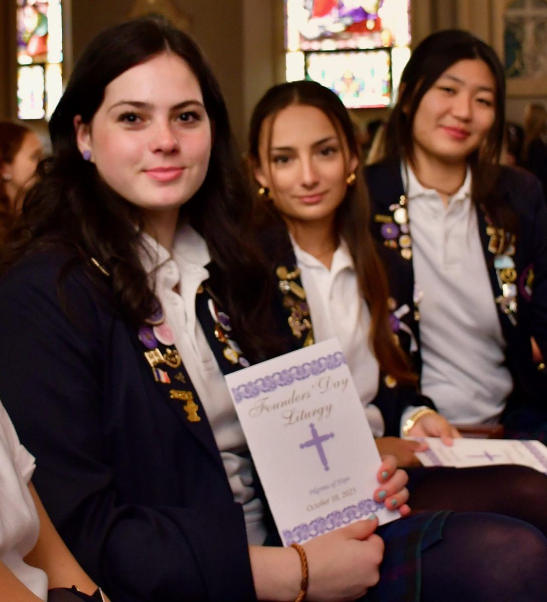 Violet Binczewski ‘26, Daria Yohe ‘26, and Emma Meng ‘26 sit together, waiting for the Mass to begin while Violet shows off the program for the Liturgy.

Seniors had the privilege of sitting in the first rows, coming face to face with the liturgical dancers, Father Kevin Deprinzio, and the word of the Lord. 

“It was bittersweet, but I think there was a lot of joy that day,” Violet Binczewski ‘26 said. “It’s special to walk to the motherhouse for the last time, and when you know it’s your last one it makes you really appreciate the day that much more.”
