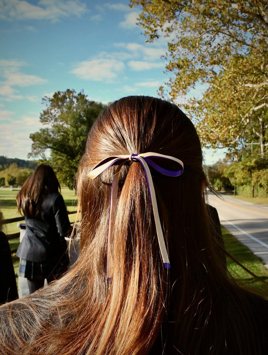 The sun shines on Daria Yohe’s purple and gold hair ribbon. 

 Adorning purple and gold ribbons in their hair is a staple of Founders’ Day. Seniors spent their morning braiding and bedazzling their peers’ hair in advisory before stepping into the sunlight of the day and beginning their walk to Chestnut Hill College. 

“My final Founders’Day was a lot of fun with all of my friends I have made friends over the years,” Daria Yohe ‘26 said. “ I am so glad to have this school community and be able to experience traditions like this one.”
