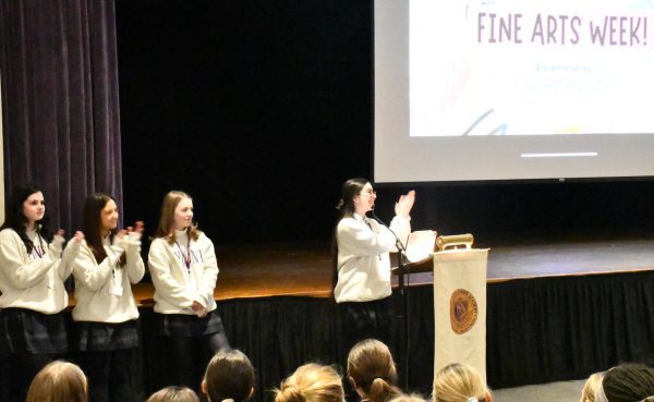 Senior Representatives of the Arts Association lead a school-wide presentation of the details regarding Fine Arts week.