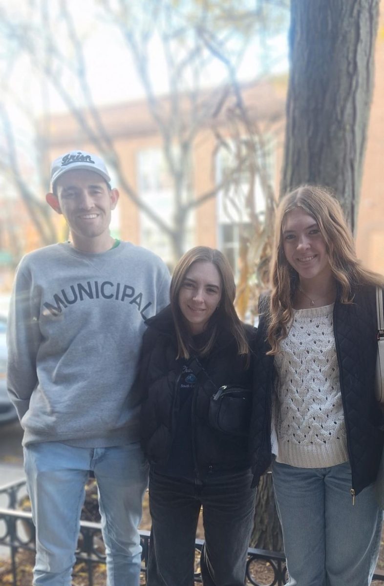 Mr. Steffe poses for a photo with his two sisters.