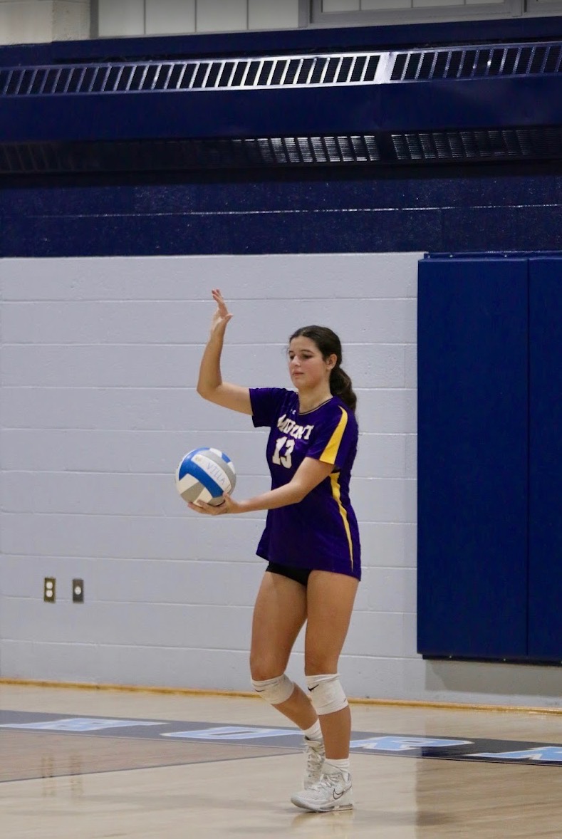 Brie focuses on her serve to win the game point.
