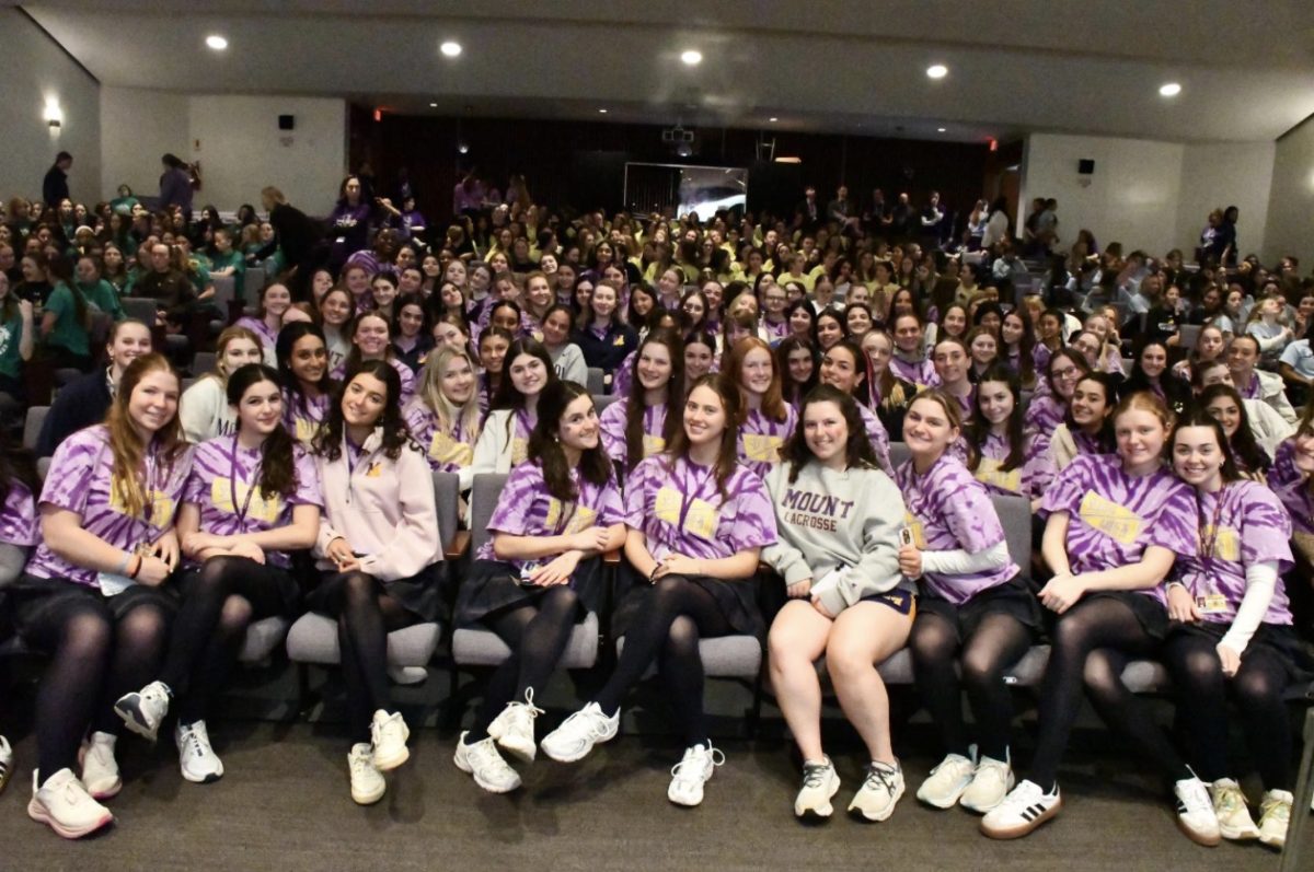 The Mount senior class smiling before the Day of Giving talent show.
