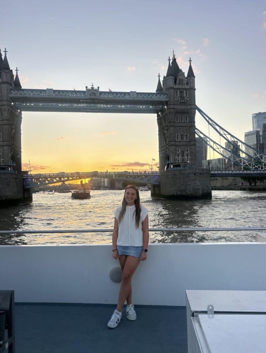 Katie Duffy smiles in front of a beautiful sunset, taking in the last days of her vacation. 