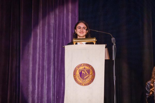 President Gabi Balaratna ‘26 speaks at SLC induction.