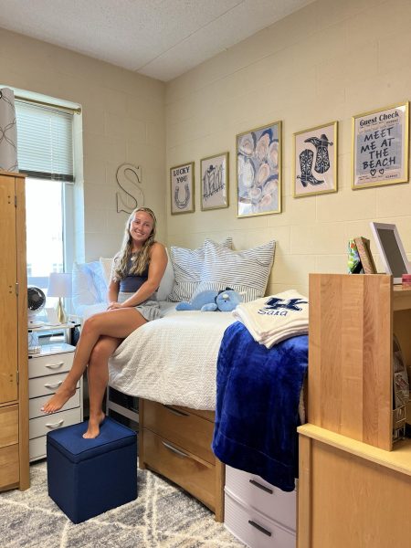 Sara Burman '25 poses for a photo in her freshmen dorm at University of Kentucky.