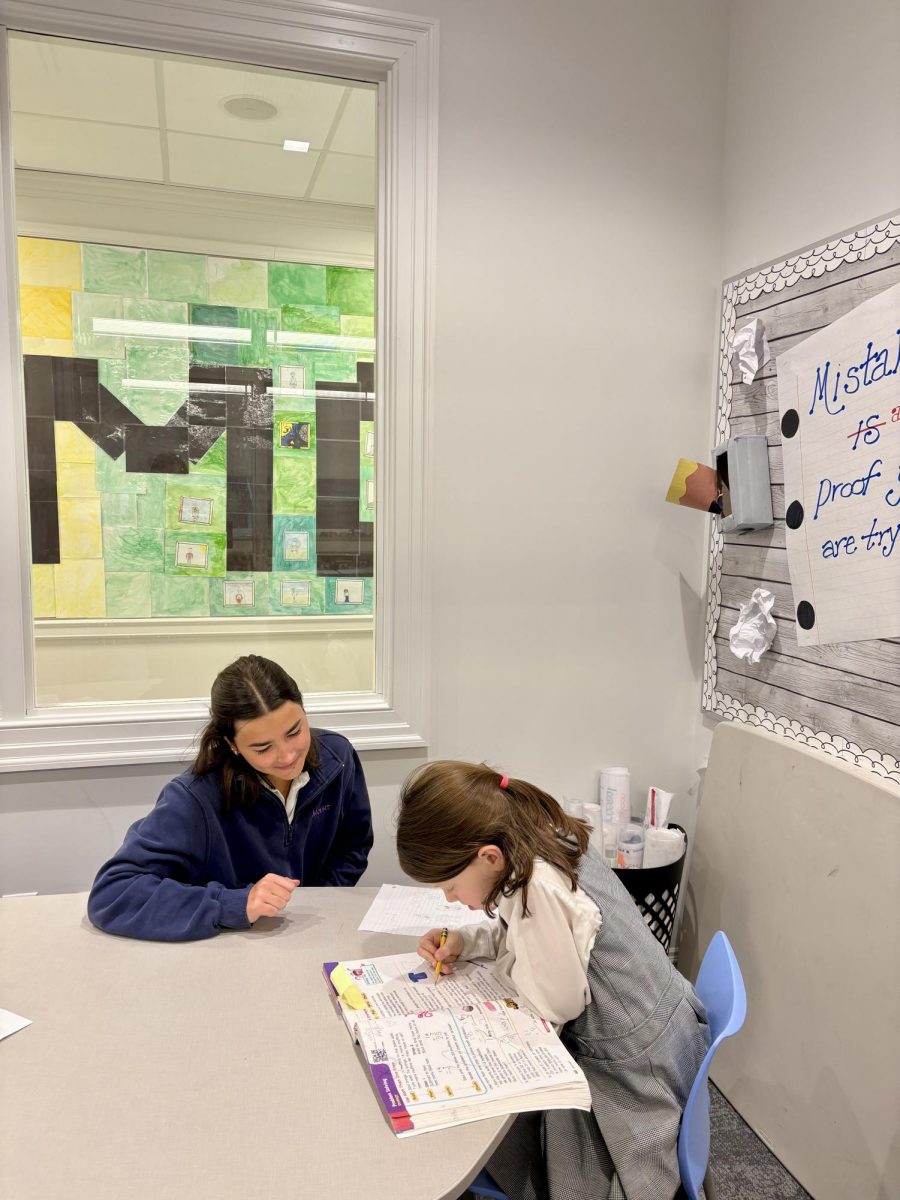 Student tutor Claire Furletti ‘27 using her expertise to help with reading. 